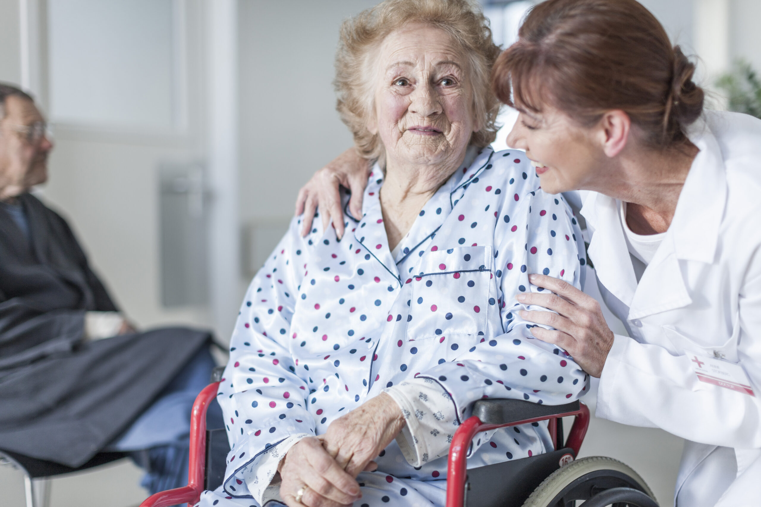 Doctor caring for elderly patient in wheelchair